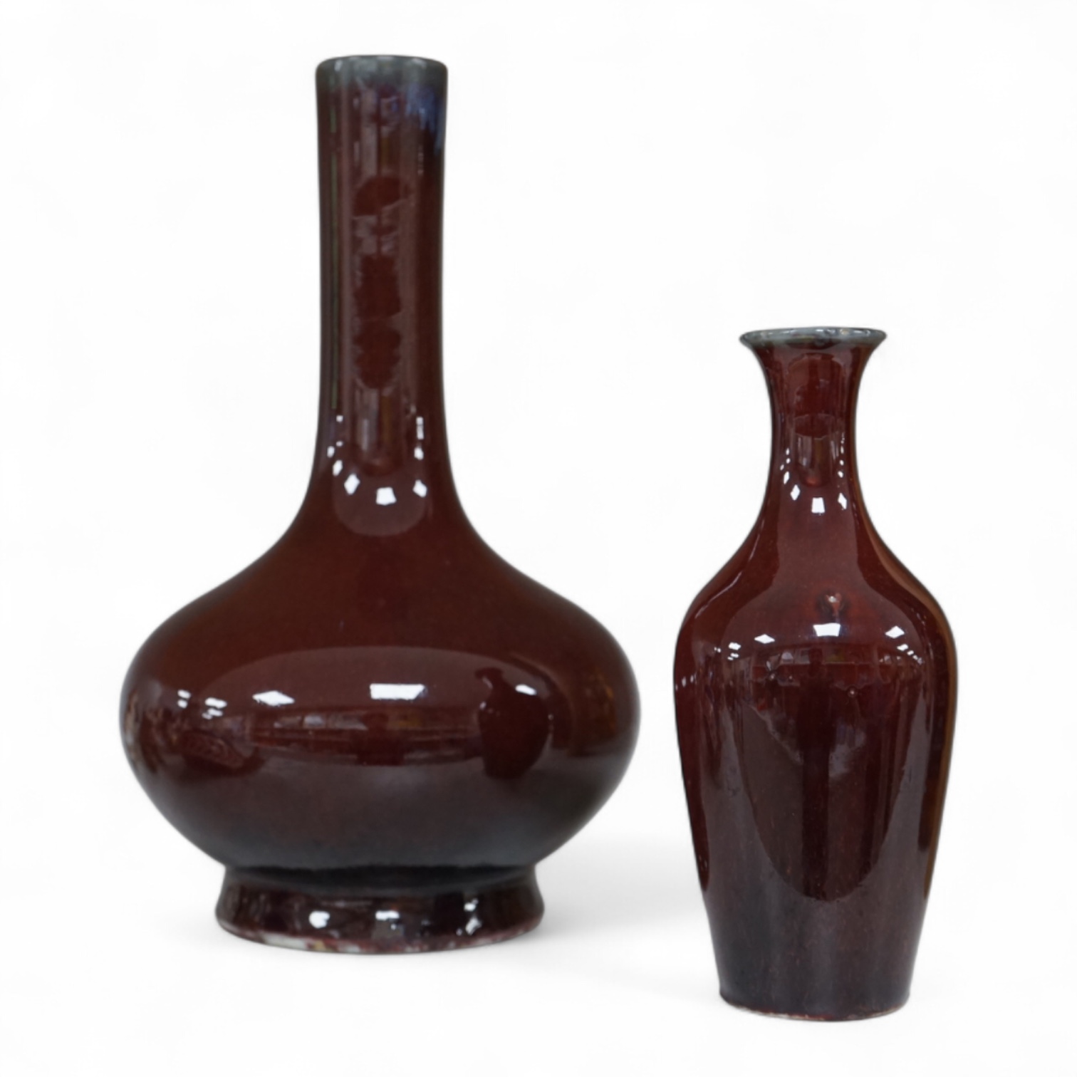 Two Chinese Sang de Boeuf glazed vases to include a bottle neck example, largest 27cm high